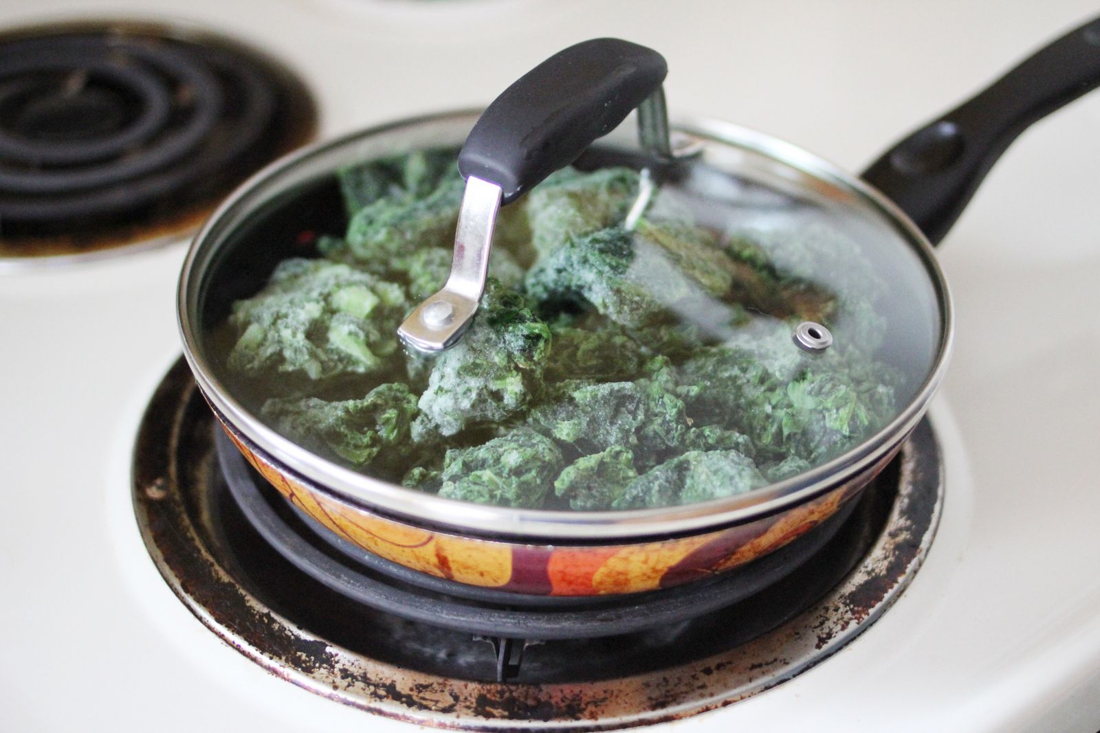 Lightly coat your pan with olive oil. Put spinach in on medium heat and
