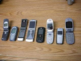 Several phones including the Motorola V60i 116 grams, Nokia 1221 106g, Motorola W370 98g, Motorola Razr GSM T-Mobile 97g, Motorola C261 Camera Phone 94g, LG 3280 93g, Nokia 2126i 86g, LG 200c 84g.