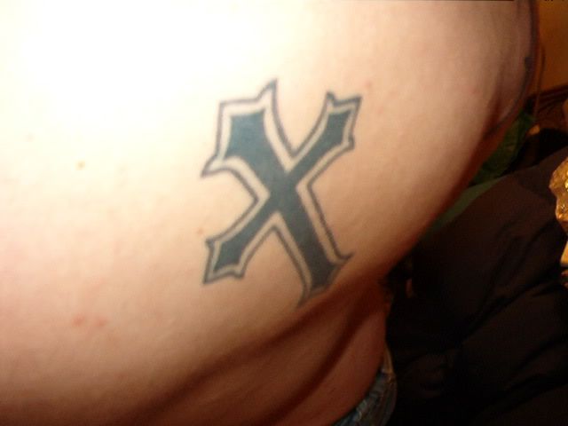 My first was a >cross< above my right shoulder blade.