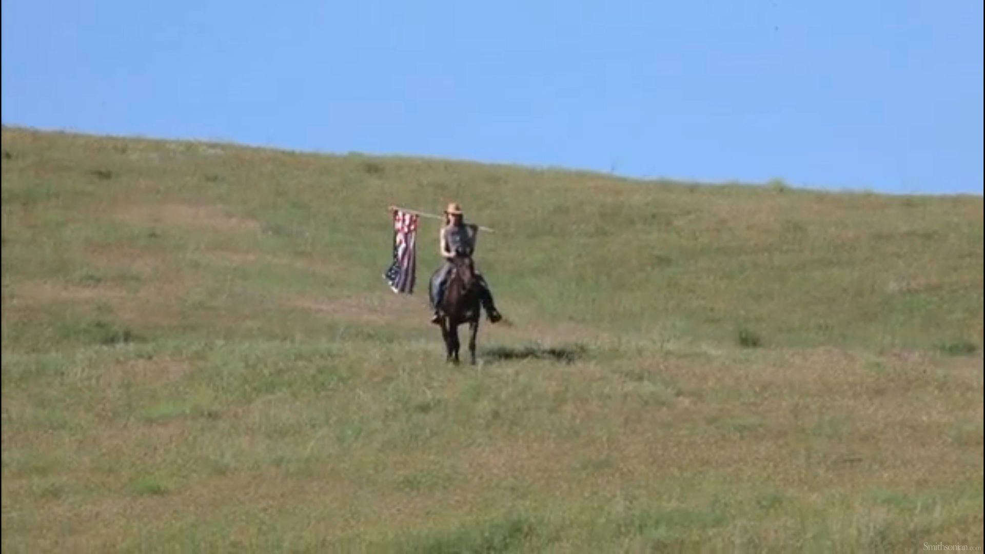 Custer actor rides in with flag