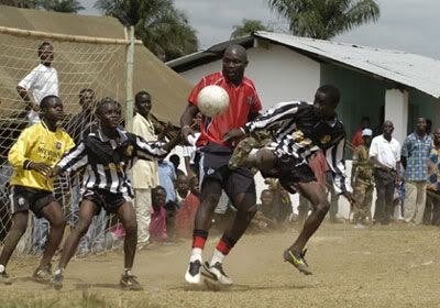 George Weah plays football with youngsters in Liberia